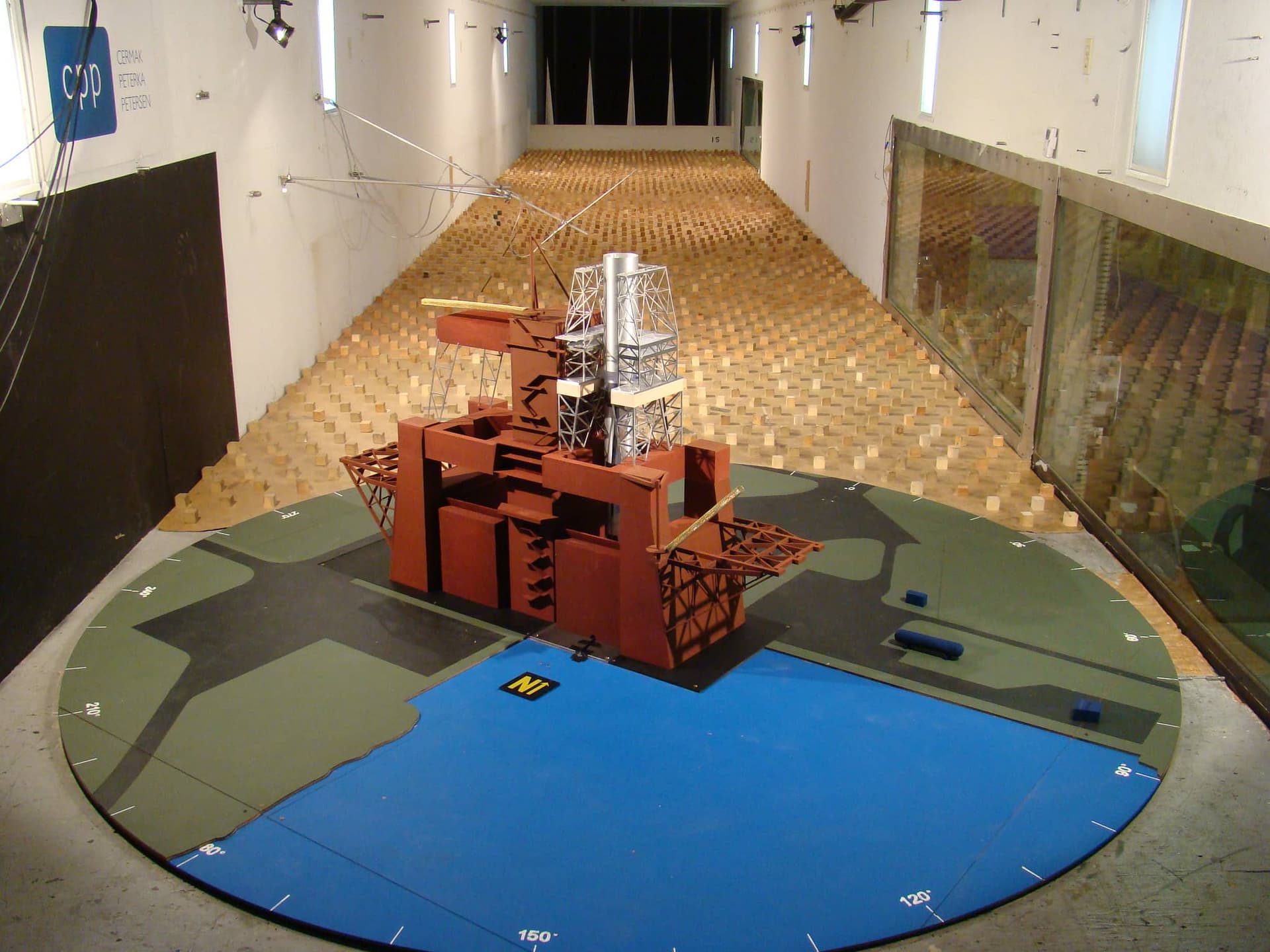 The testing of a 1:100 scale model of NASA's Space Launch System core stage B-2 test stand by CPP. The cubes and spires in the middle and background, upwind of the model, generate the required boundary layer that will be seen by the test model - Image Credit:  NASA/MSFC via Flickr licensed under CC BY-NC 2.0