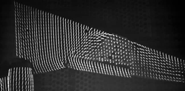 White wool tufts at different angles showing the direction of flow on a black aircraft wing