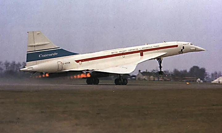 Side view of a white 1960s Concorde G-AXDN (101) on a runway