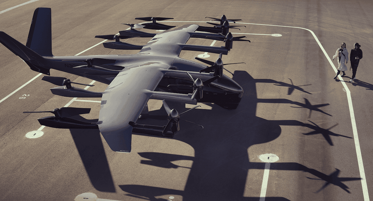 Front view of a grey eVTOL that features vertical propellors and fixed wings