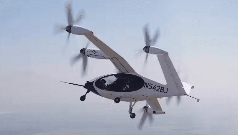 A white Joby Aviation eVTOL in flight