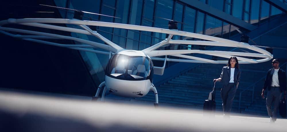 A white landed Volocity multi-rotor eVTOL landed with two passengers