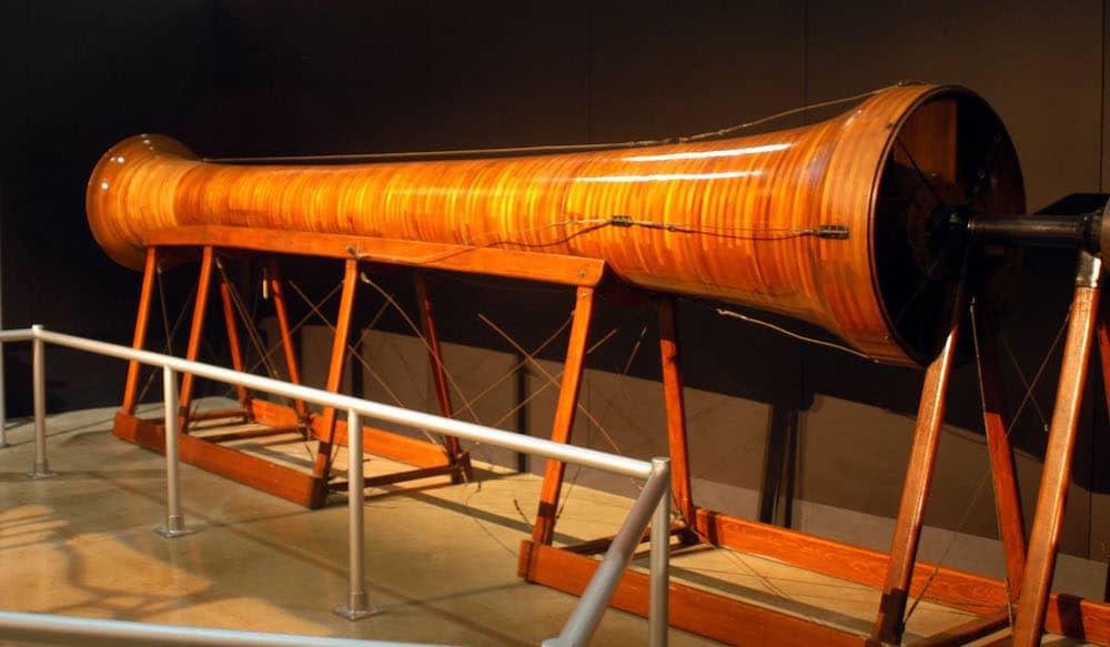 Side view of a long red, thick tube acting as a scale wind tunnel